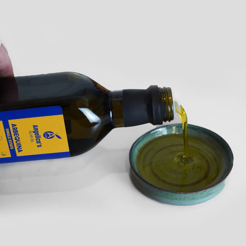 Angelica's Organic Extra Virgin Olive Oil being poured